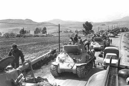 ISRAELI TANKS MOVING INTO POSITIONS FOR A COUNTER-ATTACK ON THE GOLAN HEIGHTS.
